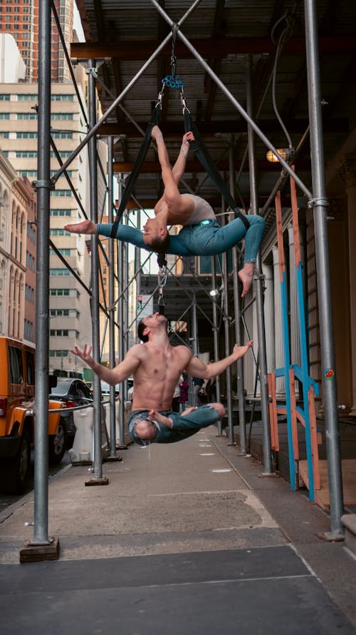 Circus Artists Performing Hair-Hanging Stunt