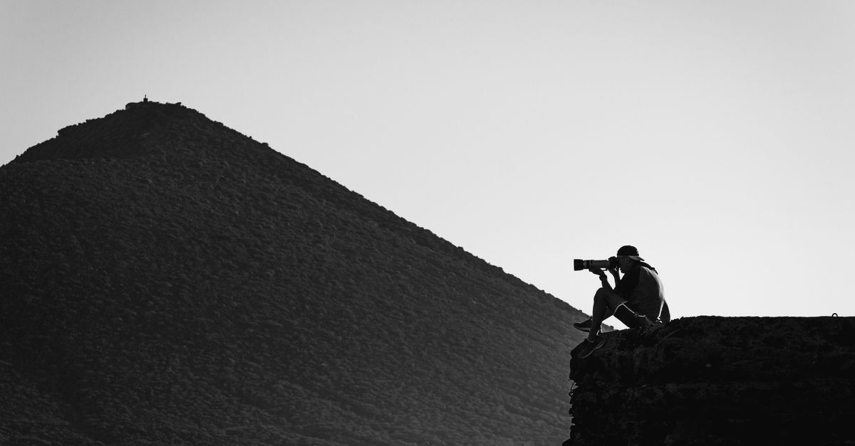 Cliff Reed Photography Black and White Shot of a Photographer Sitting on a Cliff and Taking ...