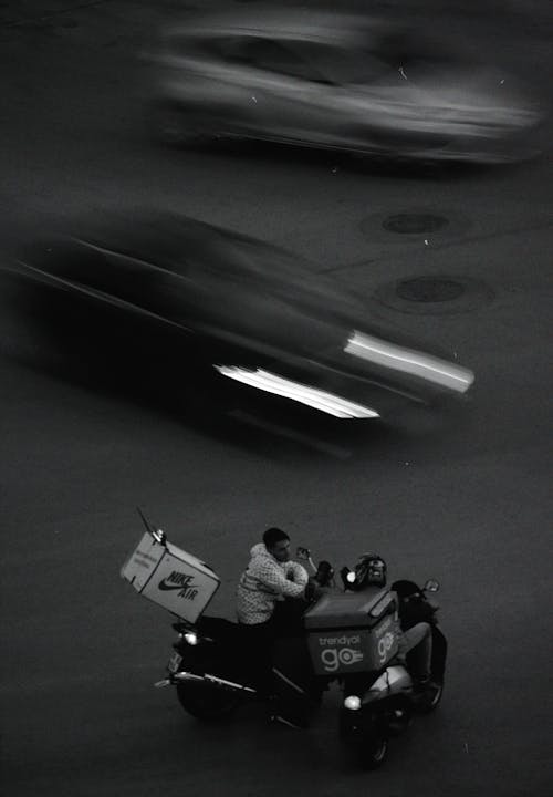 Two Delivery Couriers on Street