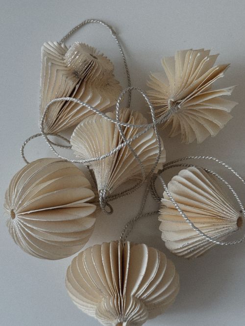 Free A set of handmade paper Christmas ornaments with intricate designs. Stock Photo