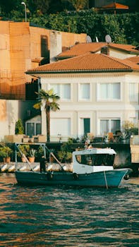 A picturesque scene of a coastal house with a boat in Istanbul, Türkiye.