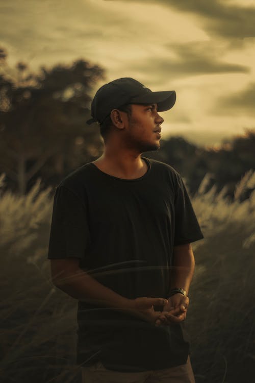 Free Man in a Baseball Cap in a Clearing Stock Photo