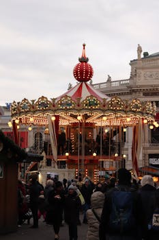 Explore the vibrant Christmas market in Vienna featuring a charming carousel amid winter festivities.