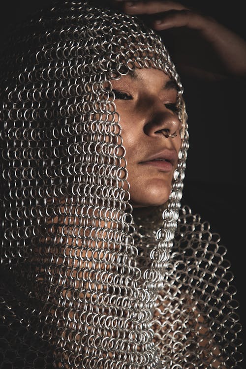 Woman Wearing a Chainmail Headpiece on her Head