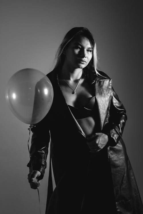 Woman in a Leather Coat with a Balloon in her Hand 