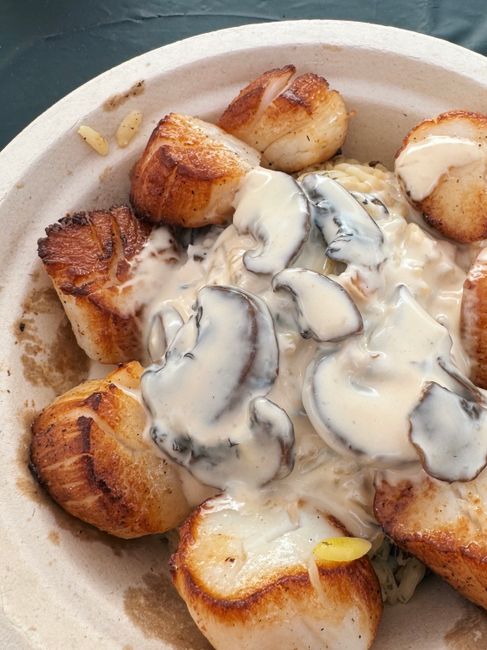 Thick rounds of seared king trumpet mushroom with deep golden crusts, arranged in a cast iron skillet with melted garlic butter and fresh thyme sprigs.