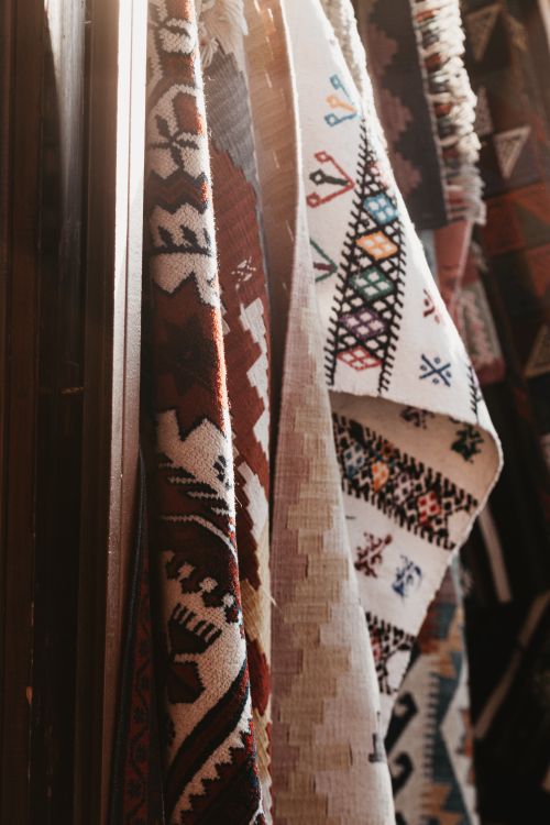 Free Close-up of colorful Turkish kilims with intricate patterns in soft sunlight, showcasing traditional culture. Stock Photo
