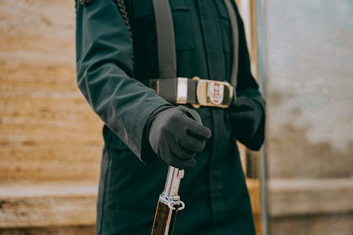 Close-up of a Soldier Hand Holding a Rifle
