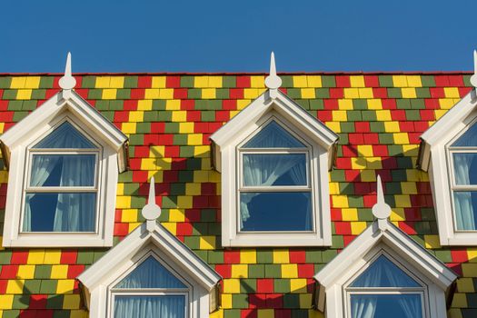A colorful building with many windows and a roof