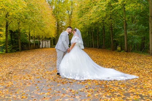 Smiling Newlyweds Together in Park in Autumn