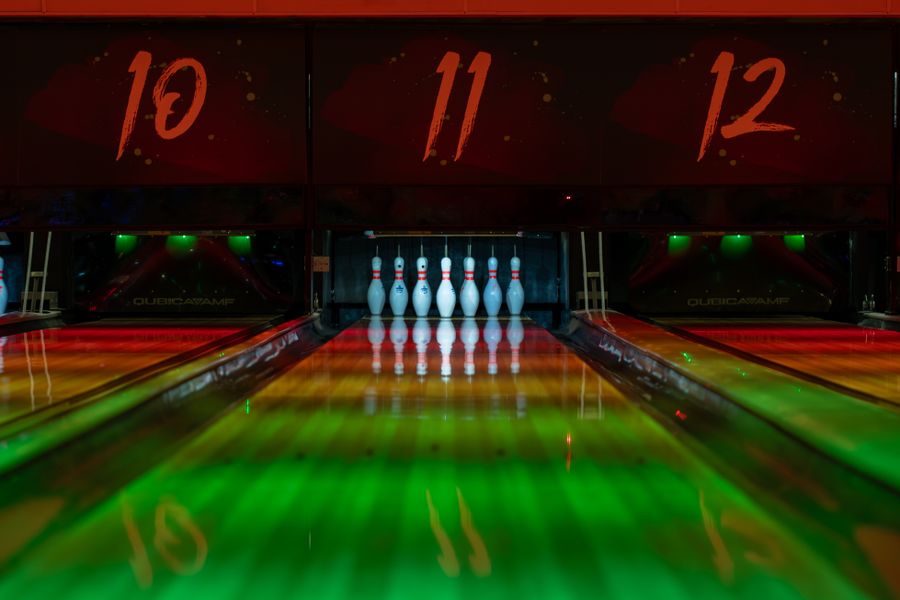 Bowling lane glowing under dramatic venue lighting