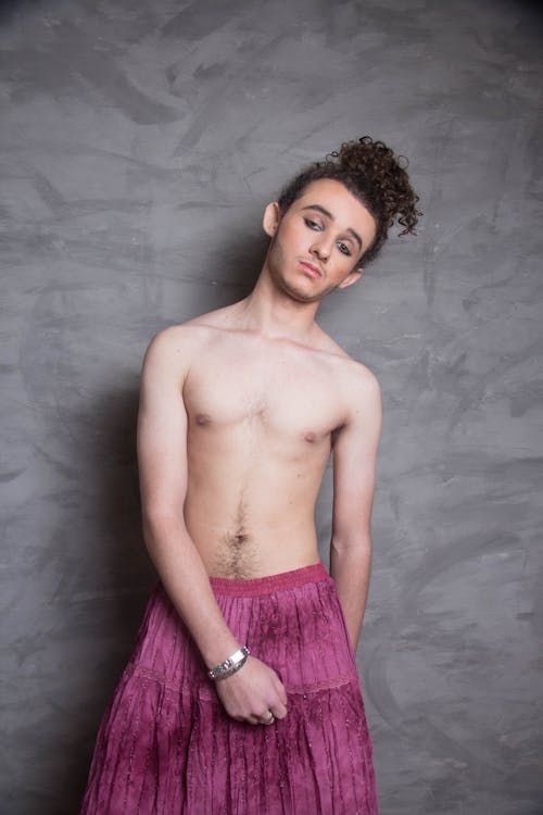 Portrait of a Shirtless Male Model Wearing a Pink Skirt