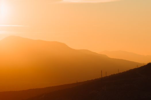 Enchanting golden sunset over the tranquil hills of Çeşme, capturing nature's serene beauty.