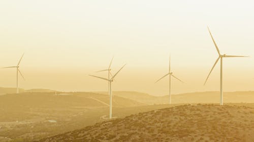 Wind Turbines on Hills at Sunset