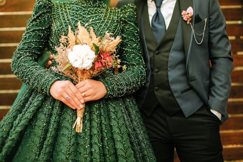 Bride in a Green Wedding Dress and the Groom Standing Close 