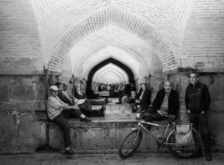 Elderly People Sitting On A Street In Iran In Black And White