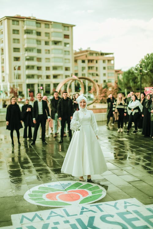 Free Bride in Wedding Dress and Smiling People behind in Malatya Stock Photo