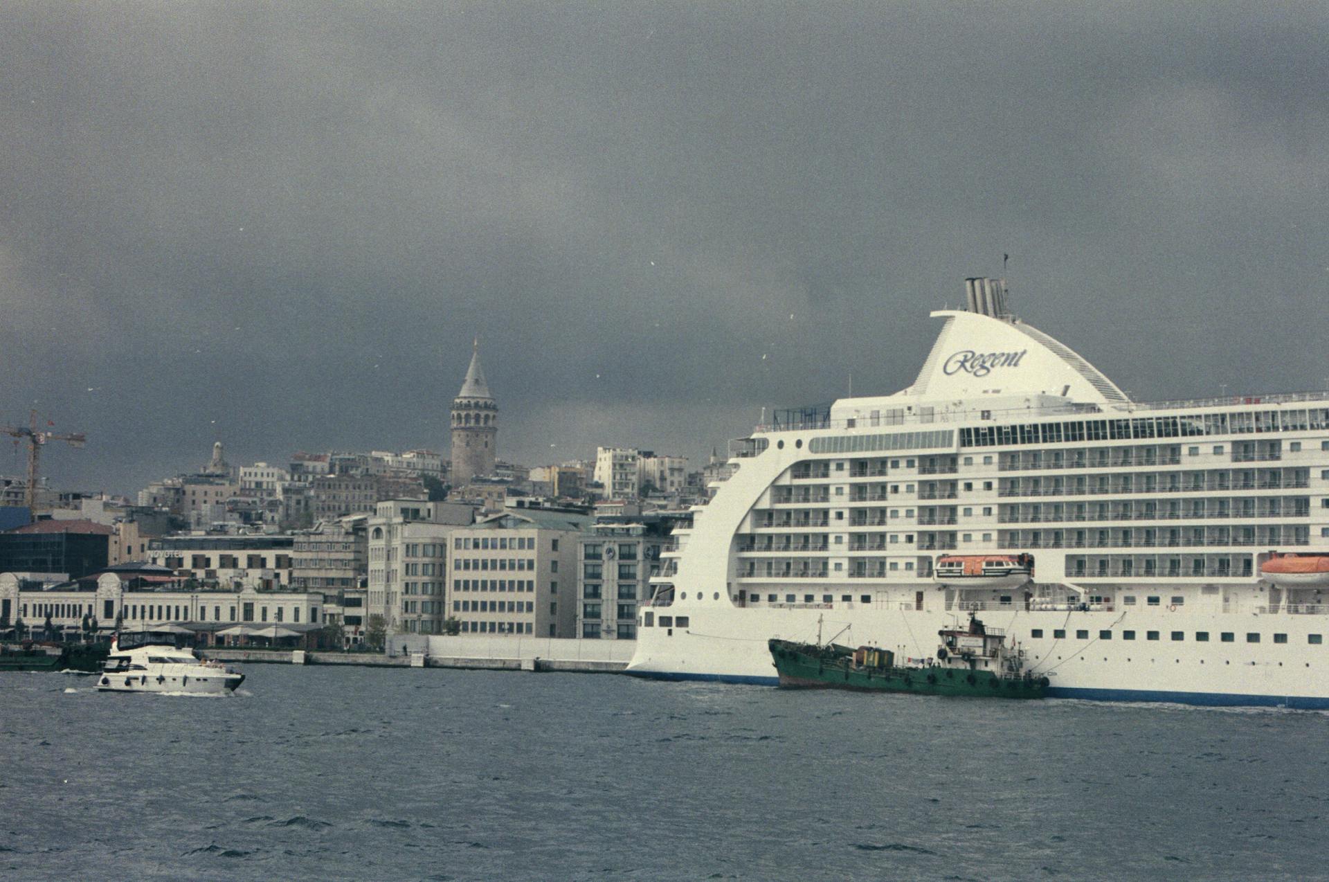 Scenic view of Galata Tower with Regent cruise ship moored in Istanbul, Turkey.