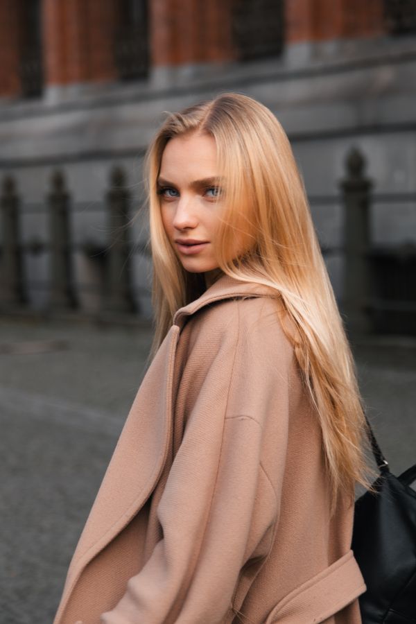 Woman wearing a relaxed camel coat over a knit set