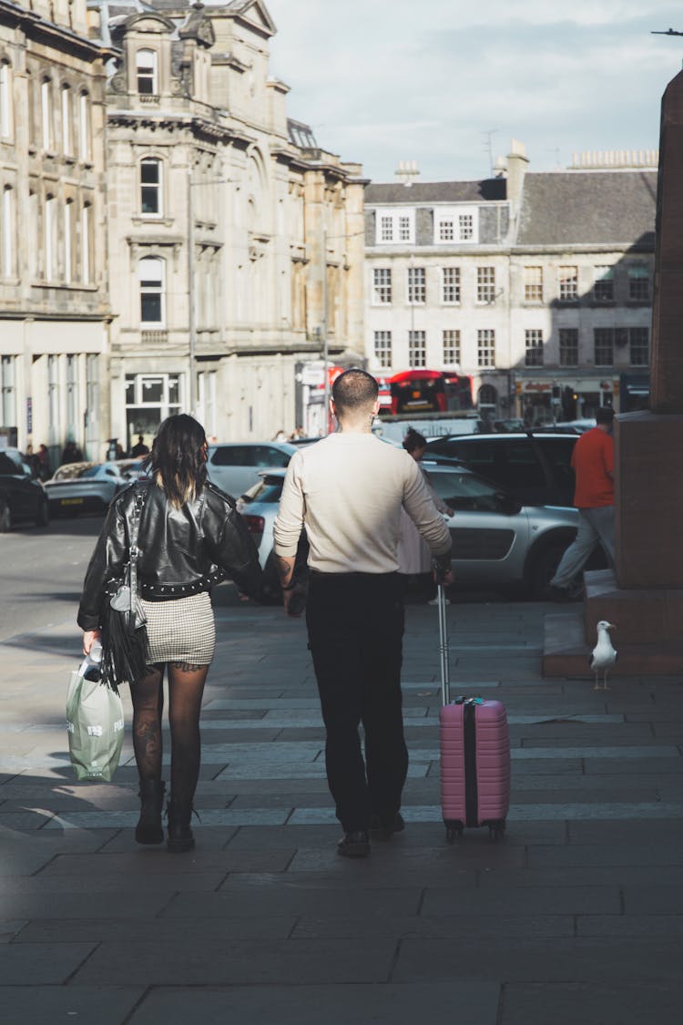 Couple Walking With Suitcase