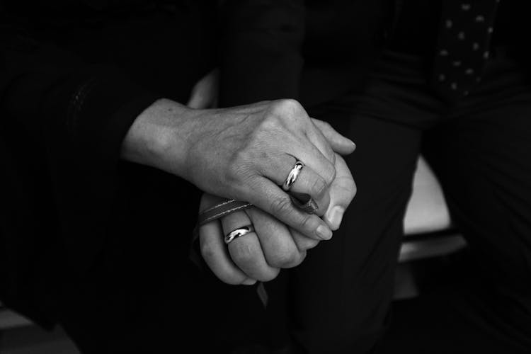 Close-up Of A Married Couple Holding Hands 