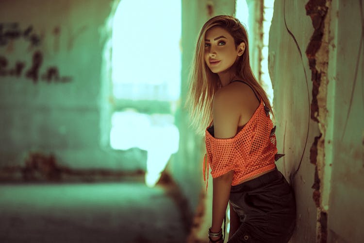 Blonde Woman Standing By Wall