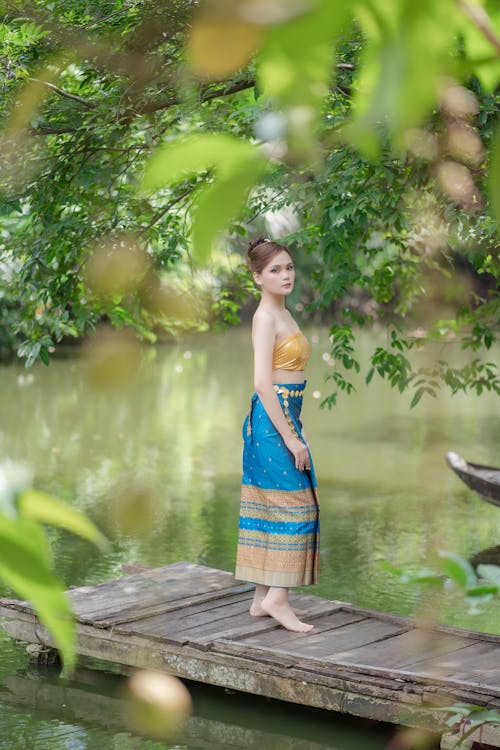 Woman in Skirt Standing on Wooden Pier on River