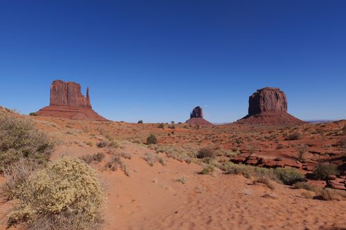 Free Stunning view of Monument Valley's iconic buttes under a bright blue sky, capturing the essence of the American Southwest. Stock Photo