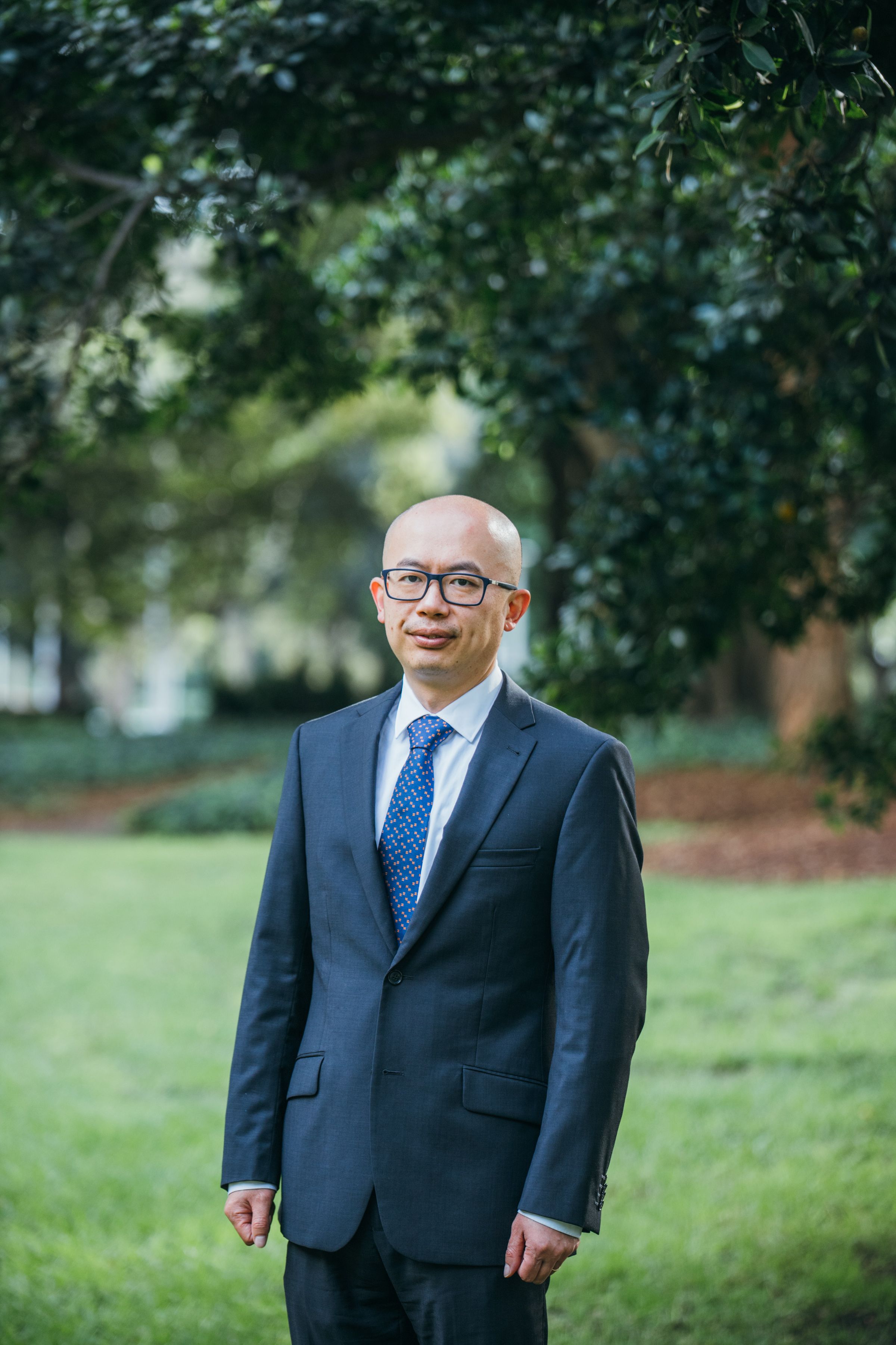 Portrait of an elegant businessman in a suit standing outdoors in Sydney, Australia.