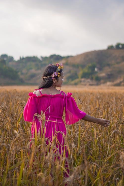 Woman in Pink Dress on Field