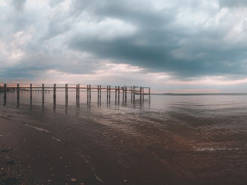 Free Tranquil coastal scene at Atlantic Highlands with a pier and dramatic sky. Stock Photo
