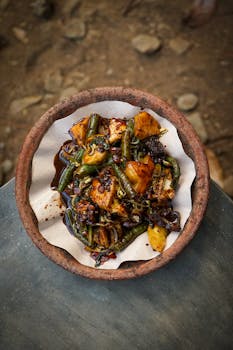 Traditional Indonesian vegetable dish in a rustic clay plate captures the essence of local cuisine.