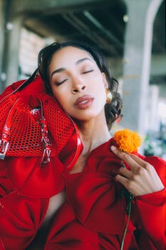 Stylish portrait of a woman in red attire holding a flower, Tokyo charm.
