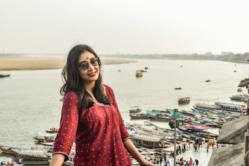 Smiling Woman in Red Dress and Sunglasses