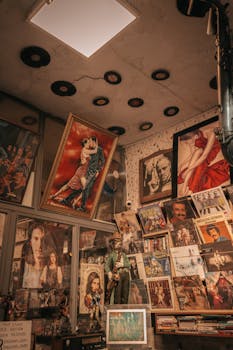 A cozy vintage store corner filled with posters, vinyl records, and framed art.