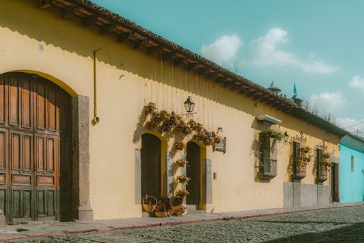 Charming colonial building with vibrant floral decor in Antigua Guatemala.