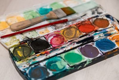 Vibrant watercolour palette with paintbrushes