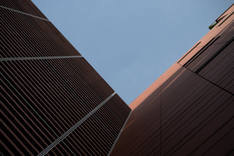 Low-angle view of modern building architecture in Treviso, Italy. Captures geometric design and sky.