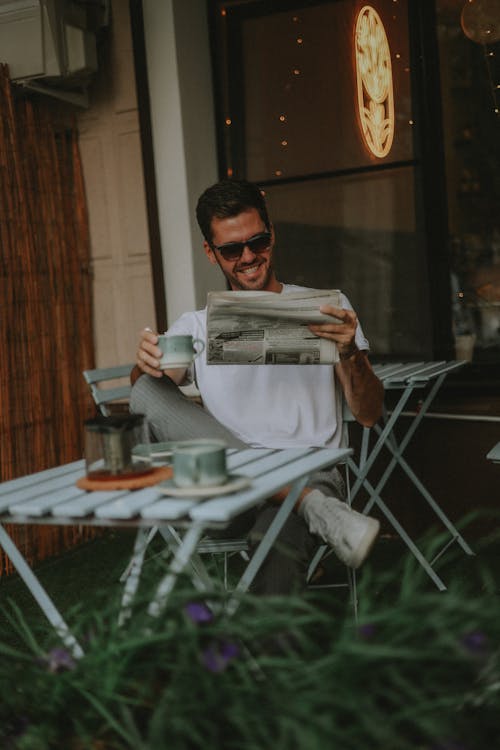 Cheerful Man Reading Newspaper