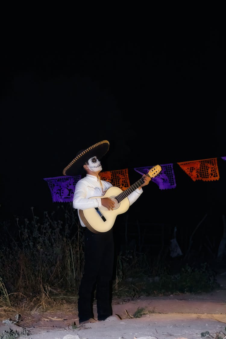 Man Wearing Traditional Mexican Costume With A Guitar 