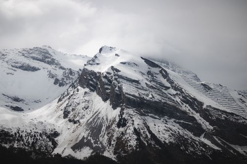 Free Breathtaking view of snow-covered peaks in Hintertux, Tirol, with dramatic clouds. Stock Photo
