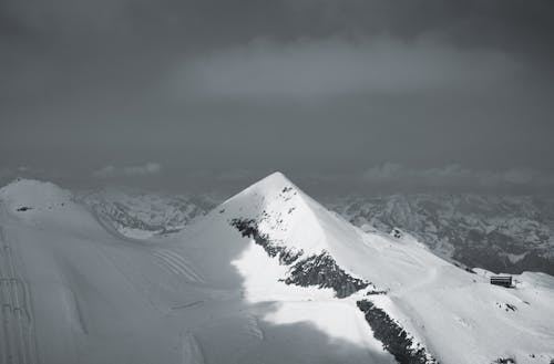 A black and white photo of a snowy mountain