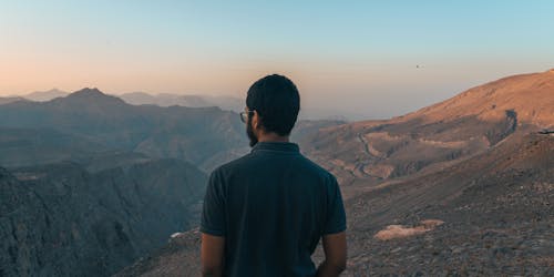 Back View of Man in Mountains