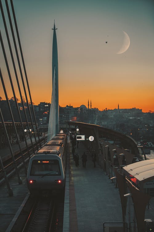 Metro Station on Halic Bridge at Sunset with Crescent over Istanbul