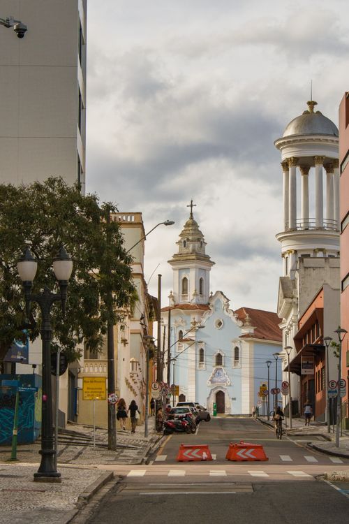Cobblestone streets and restored colonial buildings in the Largo da Ordem district of Curitiba — the historic quarter that anchors the city's weekend Sunday market.