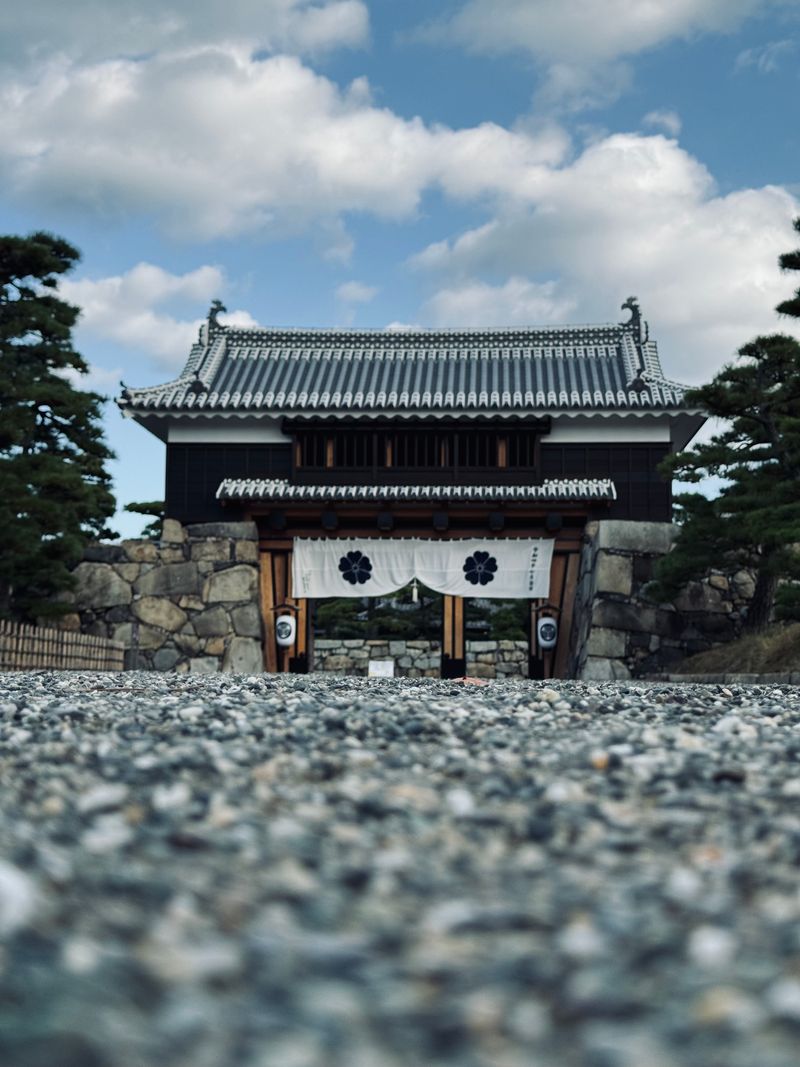 Takamatsu Castle park gate — traditional Japanese castle architecture with gravel grounds and pine trees in Kagawa