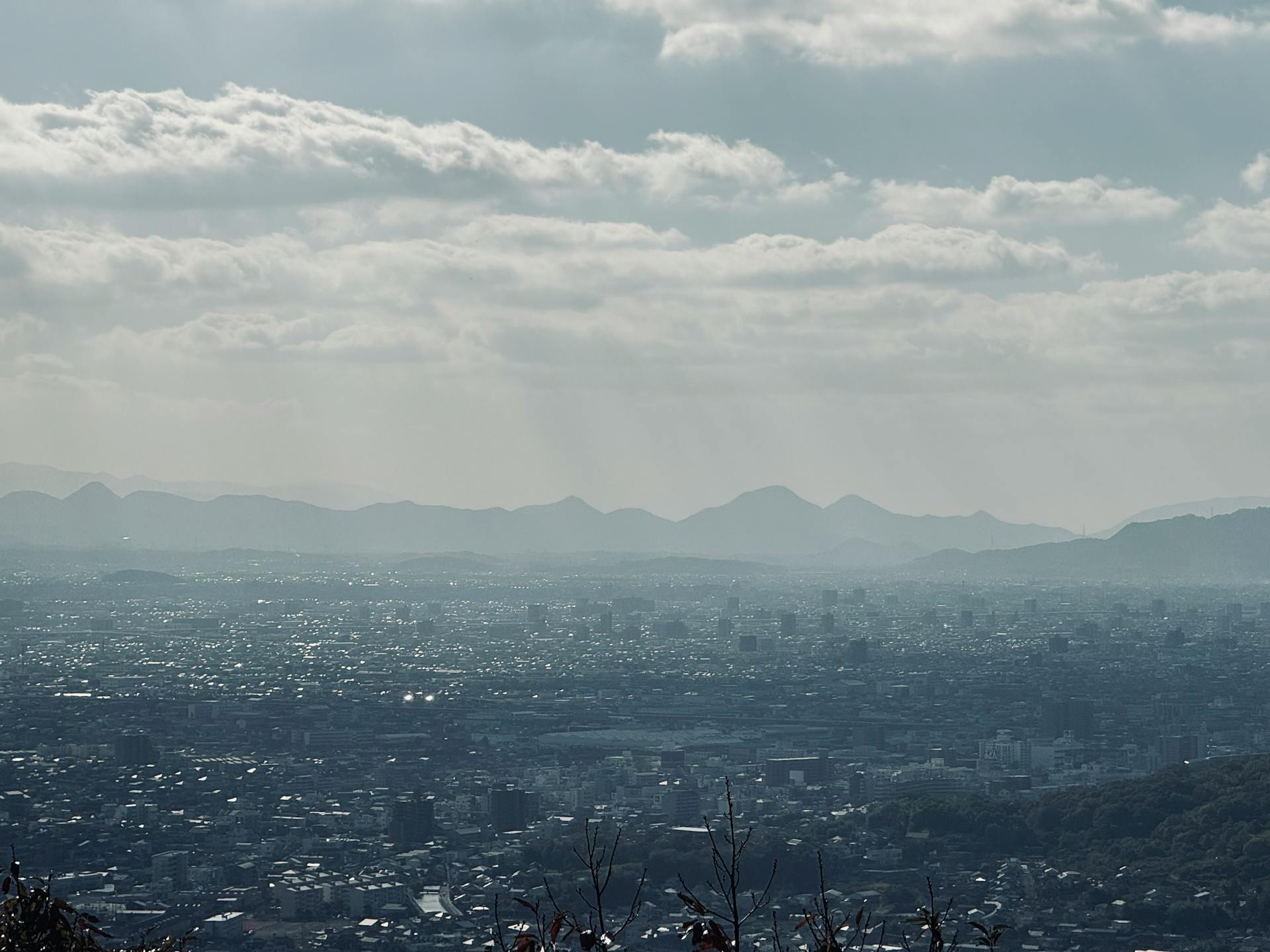 Aerial View of a City and Mountain in Distance