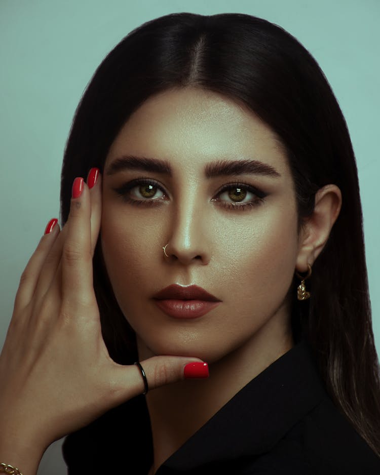 Portrait Of A Young Woman Touching Her Face