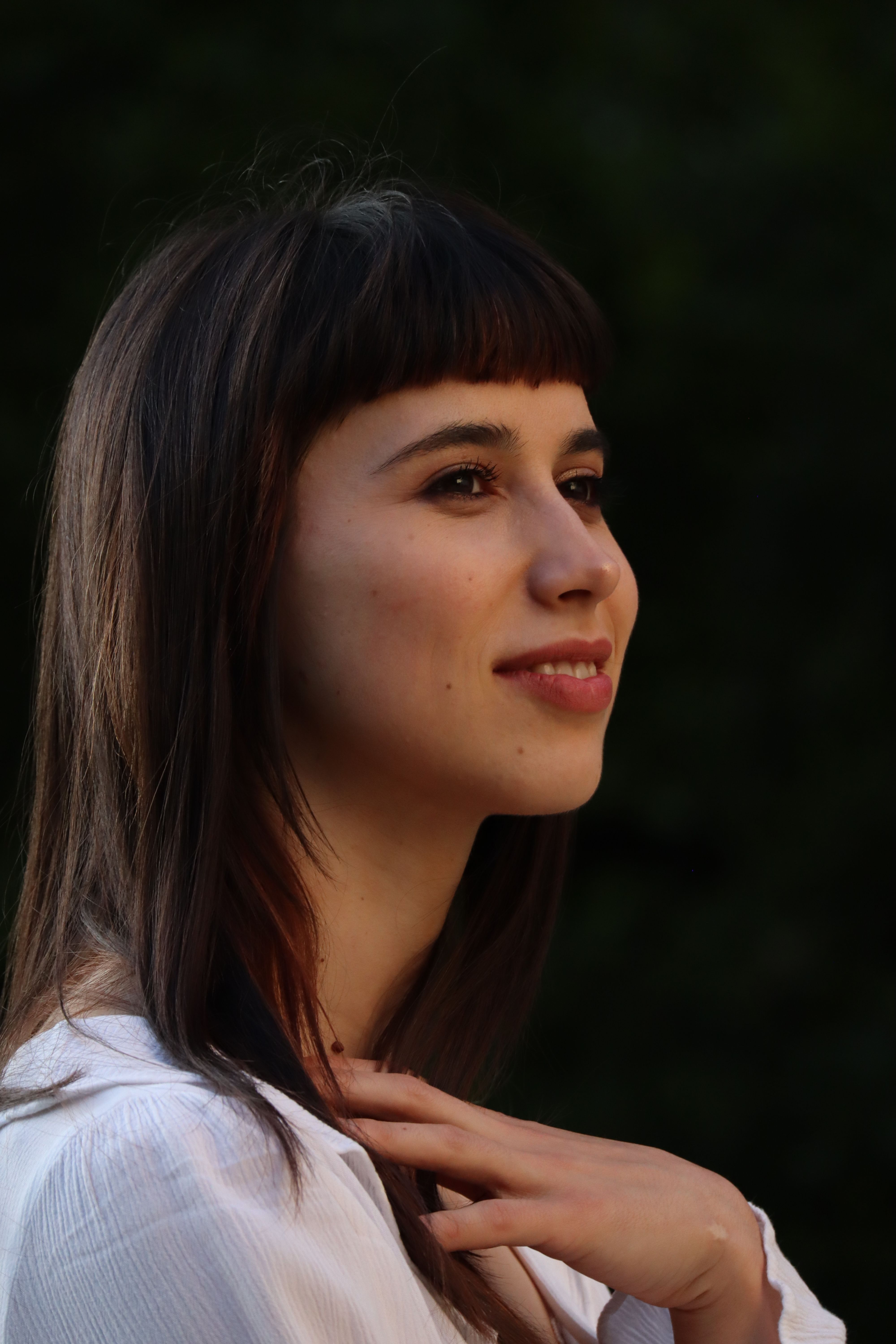 Candid portrait of a smiling woman outdoors in Berlin.
