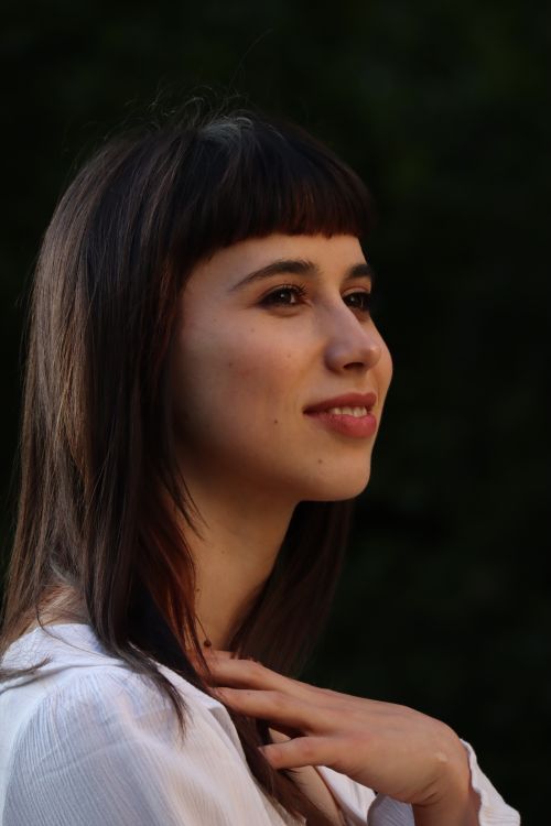 Free Candid portrait of a smiling woman outdoors in Berlin. Stock Photo